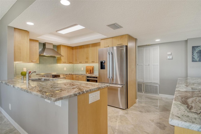 8779 Midnight Pass Rd Unit 506H, Sarasota, FL 34242 - kitchen with stainless steel appliances, wall chimney range hood, a sink, a peninsula, and a textured ceiling