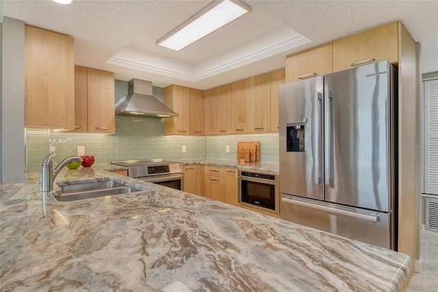 8779 Midnight Pass Rd Unit 506H, Sarasota, FL 34242 - kitchen featuring appliances with stainless steel finishes, wall chimney range hood, light brown cabinets, and a tray ceiling