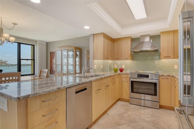 8779 Midnight Pass Rd Unit 506H, Sarasota, FL 34242 - kitchen featuring light brown cabinets, wall chimney exhaust hood, stainless steel appliances, a sink, and a peninsula
