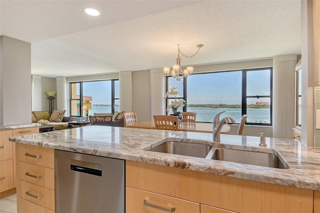 8779 Midnight Pass Rd Unit 506H, Sarasota, FL 34242 - kitchen with light brown cabinets, stainless steel dishwasher, a sink, light stone countertops, and a chandelier