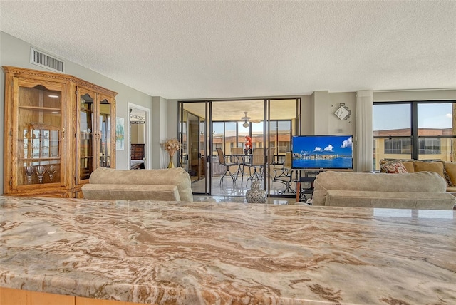 8779 Midnight Pass Rd Unit 506H, Sarasota, FL 34242 - living room with a textured ceiling and expansive windows