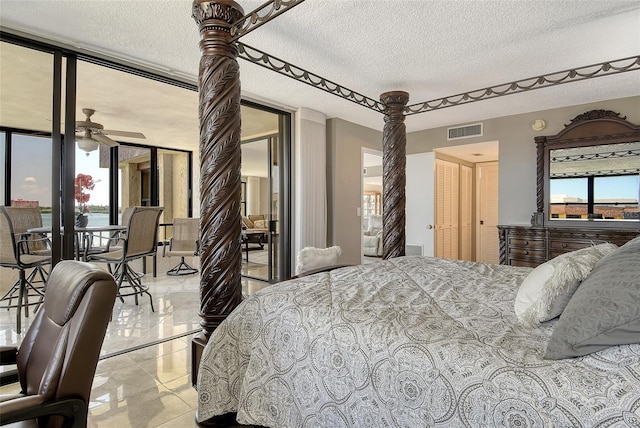 8779 Midnight Pass Rd Unit 506H, Sarasota, FL 34242 - bedroom featuring a textured ceiling and access to exterior
