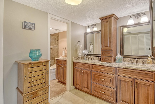 8779 Midnight Pass Rd Unit 506H, Sarasota, FL 34242 - bathroom with double vanity, toilet, and a textured ceiling