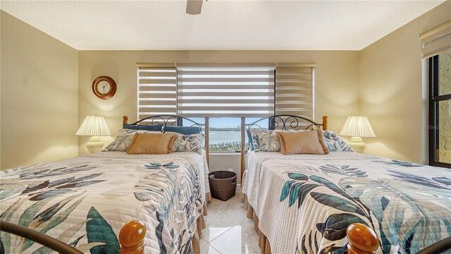 8779 Midnight Pass Rd Unit 506H, Sarasota, FL 34242 - bedroom featuring tile patterned floors and ceiling fan