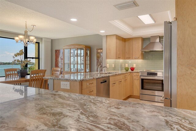 8779 Midnight Pass Rd Unit 506H, Sarasota, FL 34242 - kitchen with wall chimney range hood, light brown cabinetry, stainless steel appliances, light stone countertops, and tasteful backsplash