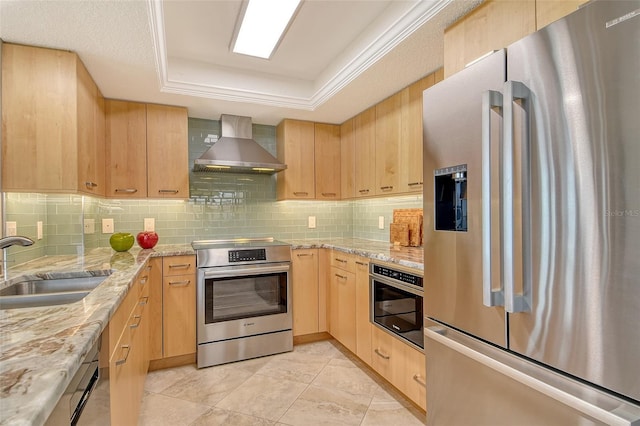 8779 Midnight Pass Rd Unit 506H, Sarasota, FL 34242 - kitchen with appliances with stainless steel finishes, wall chimney exhaust hood, a tray ceiling, light brown cabinets, and backsplash