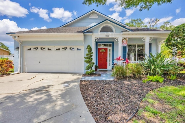 11208 Blue Sage Pl, Lakewood Ranch, FL 34202 - view of front of house featuring concrete driveway, a garage, stucco siding, and a shingled roof
