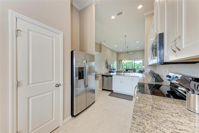 13710 Messina Loop Unit 201, Bradenton, FL 34211 - kitchen featuring stainless steel appliances, a peninsula, a sink, ornamental molding, and light tile patterned floors