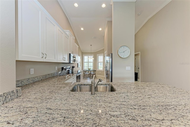 13710 Messina Loop Unit 201, Bradenton, FL 34211 - kitchen with a sink, appliances with stainless steel finishes, light stone countertops, white cabinets, and recessed lighting