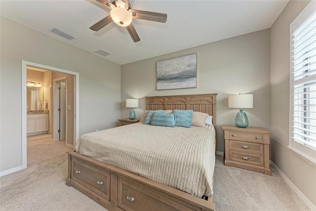 13710 Messina Loop Unit 201, Bradenton, FL 34211 - bedroom with light carpet, baseboards, ceiling fan, and ensuite bath