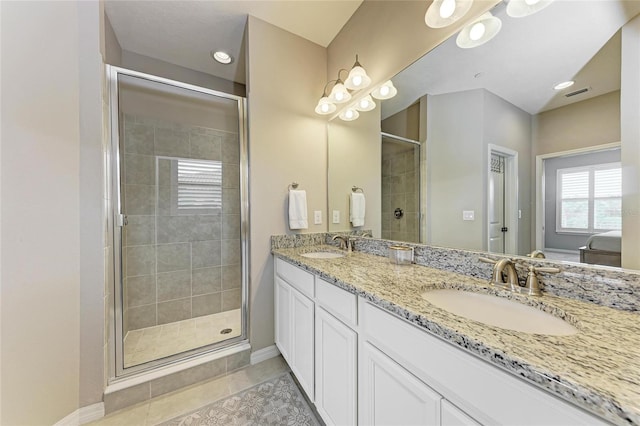 13710 Messina Loop Unit 201, Bradenton, FL 34211 - full bath featuring double vanity, a shower stall, tile patterned floors, and baseboards