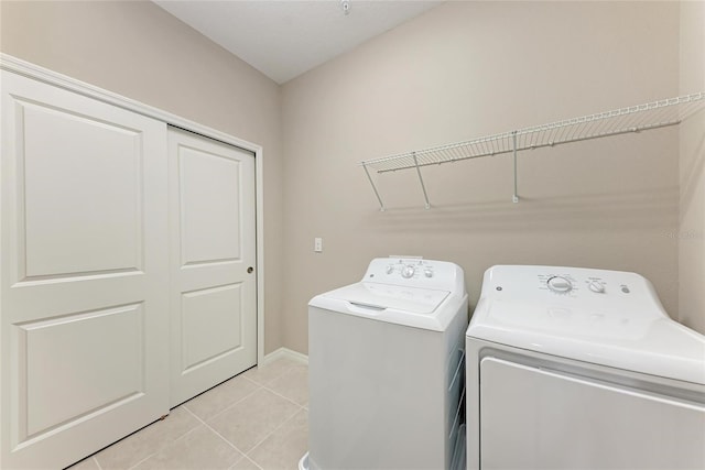 13710 Messina Loop Unit 201, Bradenton, FL 34211 - washroom featuring separate washer and dryer, light tile patterned floors, and baseboards