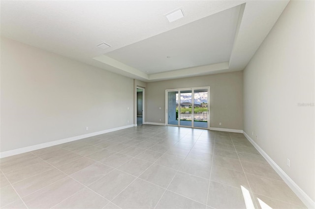 4210 Sea Marsh Pl, Parrish, FL 34219 - empty room with a raised ceiling, light tile patterned floors, and baseboards