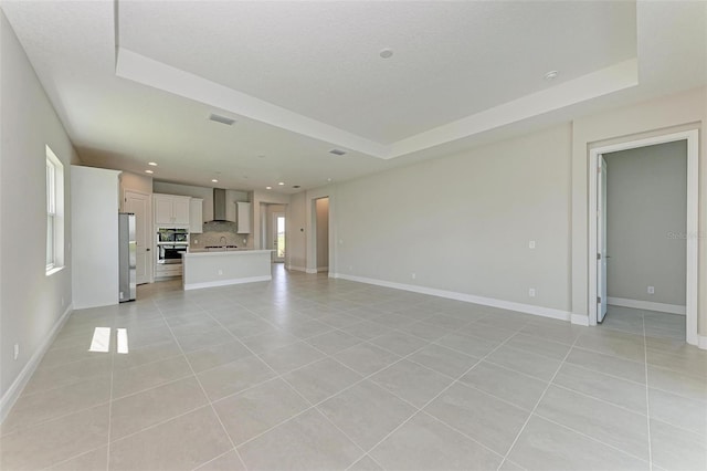 4210 Sea Marsh Pl, Parrish, FL 34219 - unfurnished living room featuring a raised ceiling, light tile patterned floors, baseboards, and recessed lighting
