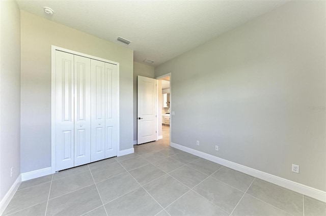 4210 Sea Marsh Pl, Parrish, FL 34219 - unfurnished bedroom with light tile patterned floors, baseboards, and a closet