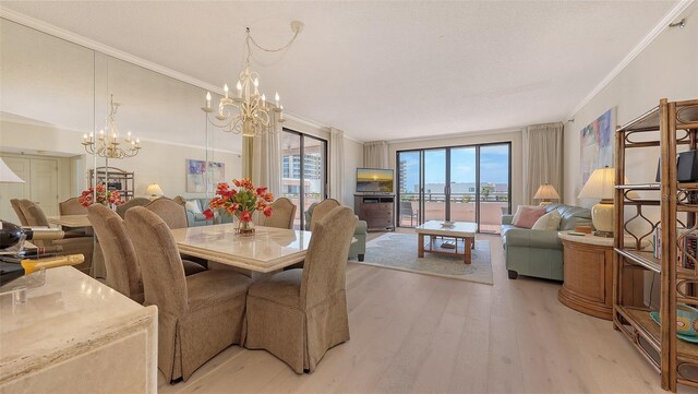 1465 Gulf Of Mexico Dr Unit 502, Longboat Key, FL 34228 - dining space featuring a chandelier, light wood-style flooring, and crown molding
