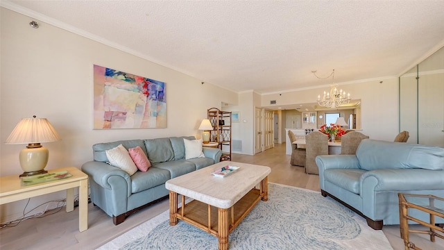 1465 Gulf Of Mexico Dr Unit 502, Longboat Key, FL 34228 - living area with a chandelier, ornamental molding, light wood-style flooring, and a textured ceiling