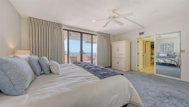 1465 Gulf Of Mexico Dr Unit 502, Longboat Key, FL 34228 - bedroom with carpet floors, access to exterior, a textured ceiling, and ceiling fan