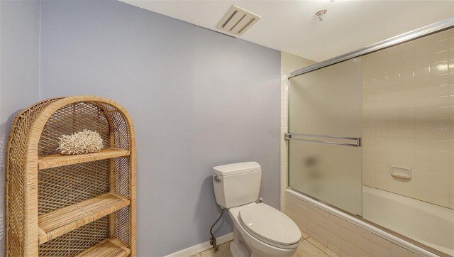 1465 Gulf Of Mexico Dr Unit 502, Longboat Key, FL 34228 - bathroom with combined bath / shower with glass door and toilet