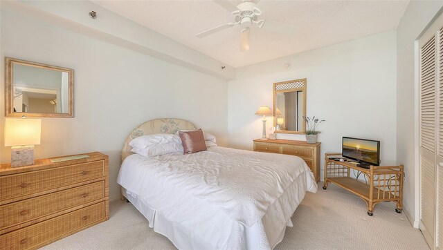 1465 Gulf Of Mexico Dr Unit 502, Longboat Key, FL 34228 - bedroom featuring light colored carpet, a closet, and a ceiling fan