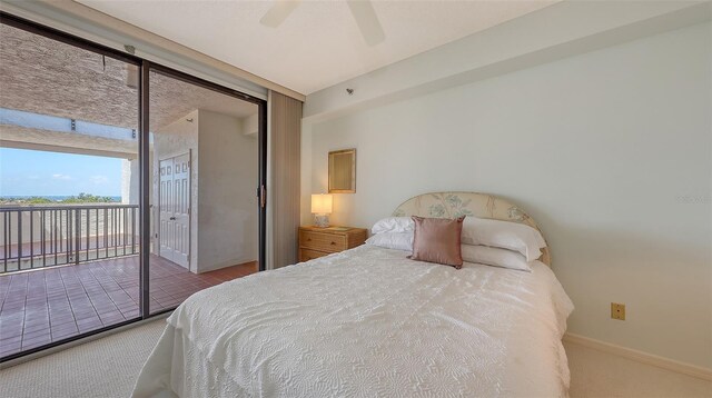 1465 Gulf Of Mexico Dr Unit 502, Longboat Key, FL 34228 - bedroom with access to outside, carpet floors, baseboards, and a ceiling fan