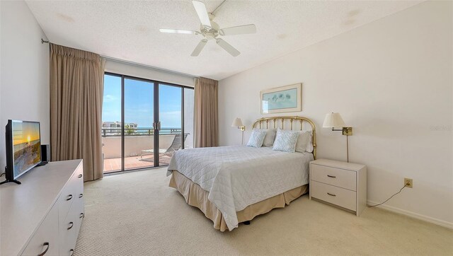 1465 Gulf Of Mexico Dr Unit 502, Longboat Key, FL 34228 - bedroom with light carpet, access to outside, a textured ceiling, ceiling fan, and baseboards