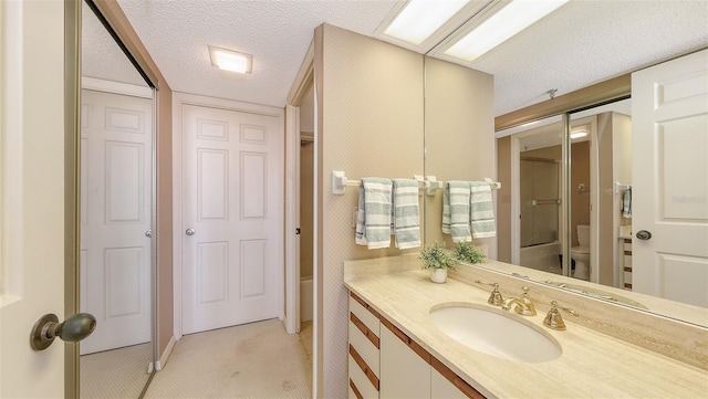 1465 Gulf Of Mexico Dr Unit 502, Longboat Key, FL 34228 - full bath with toilet, a textured ceiling, vanity, a shower, and a closet