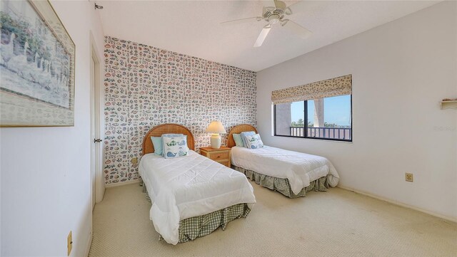 1465 Gulf Of Mexico Dr Unit 502, Longboat Key, FL 34228 - bedroom featuring carpet floors, an accent wall, wallpapered walls, and ceiling fan