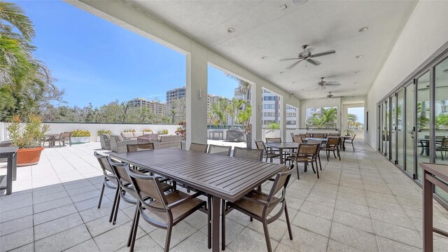 1465 Gulf Of Mexico Dr Unit 502, Longboat Key, FL 34228 - view of patio with outdoor dining space, a ceiling fan, and an outdoor living space