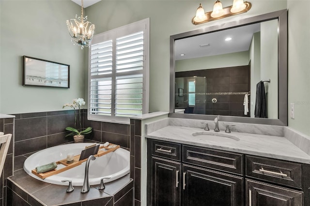 932 Mangrove Edge Ct, Bradenton, FL 34208 - bathroom with vanity, a garden tub, and a chandelier