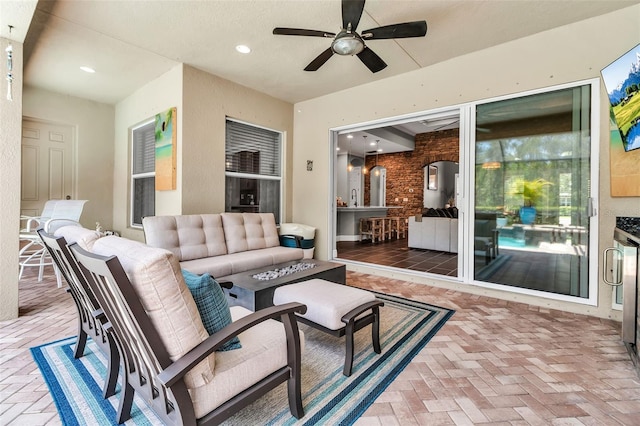932 Mangrove Edge Ct, Bradenton, FL 34208 - view of patio / terrace featuring an outdoor living space with a fire pit and a ceiling fan