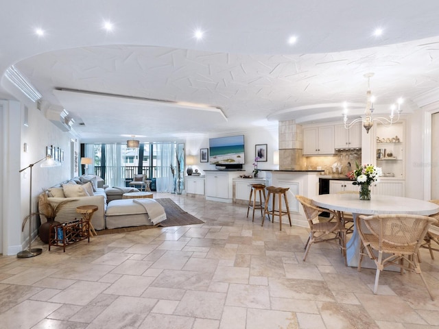 5880 Midnight Pass Rd Unit 207, Sarasota, FL 34242 - dining area featuring stone tile flooring, a chandelier, and recessed lighting