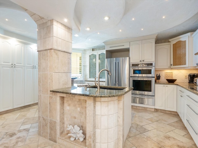 5880 Midnight Pass Rd Unit 207, Sarasota, FL 34242 - kitchen featuring a warming drawer, stainless steel appliances, dark stone countertops, a sink, and recessed lighting
