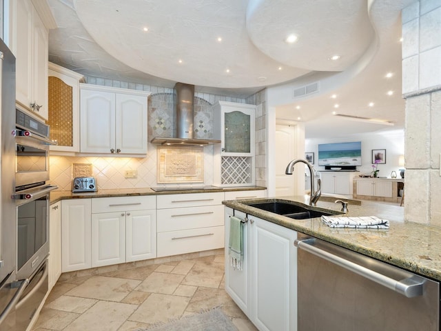5880 Midnight Pass Rd Unit 207, Sarasota, FL 34242 - kitchen featuring stainless steel appliances, a sink, a warming drawer, decorative backsplash, and light stone counters