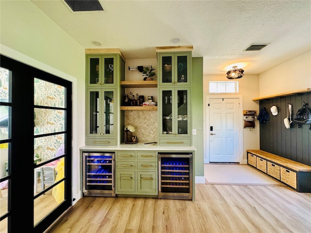 15207 Searobbin Dr, Lakewood Ranch, FL 34202 - indoor dry bar featuring wine cooler, light wood finished floors, a textured ceiling, and backsplash