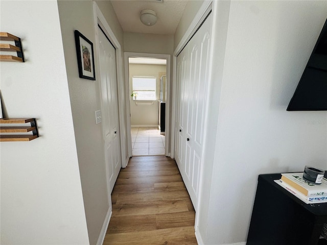 15207 Searobbin Dr, Lakewood Ranch, FL 34202 - hallway with light wood-style flooring and baseboards