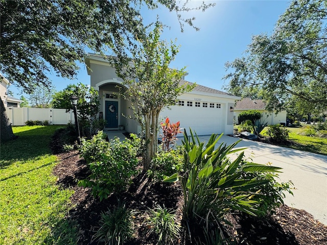 15207 Searobbin Dr, Lakewood Ranch, FL 34202 - obstructed view of property featuring driveway, an attached garage, and stucco siding