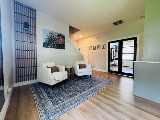 15207 Searobbin Dr, Lakewood Ranch, FL 34202 - sitting room with wood finished floors, stairway, and baseboards