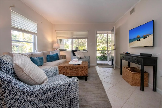 3745 Almeria Ave Unit 7S, Sarasota, FL 34239 - living area featuring light tile patterned floors, crown molding, and baseboards