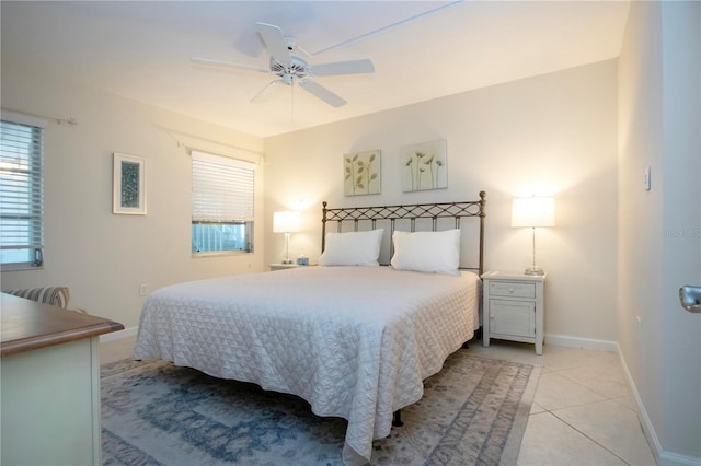 3745 Almeria Ave Unit 7S, Sarasota, FL 34239 - bedroom featuring light tile patterned floors, multiple windows, baseboards, and ceiling fan