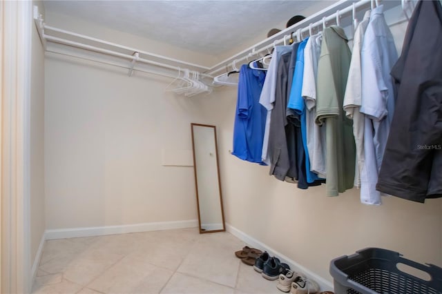 3745 Almeria Ave Unit 7S, Sarasota, FL 34239 - walk in closet featuring tile patterned flooring