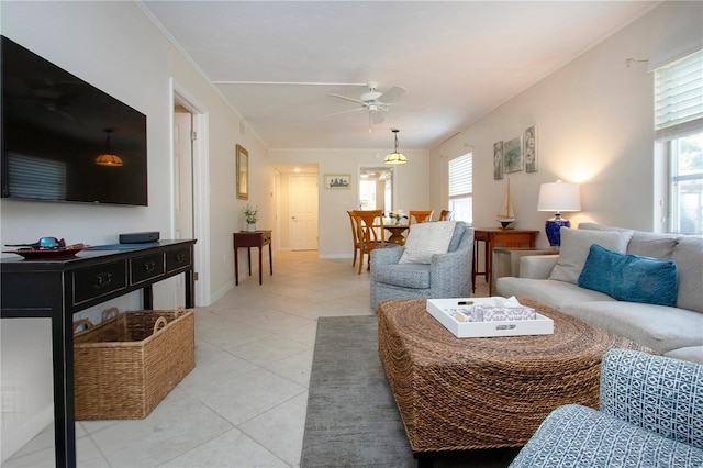 3745 Almeria Ave Unit 7S, Sarasota, FL 34239 - living room featuring a ceiling fan, plenty of natural light, light tile patterned floors, and baseboards