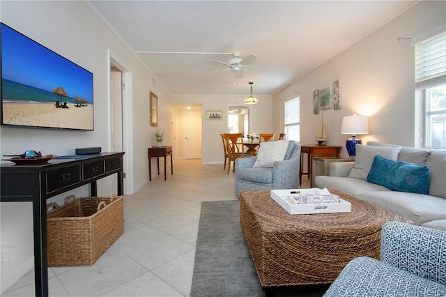 3745 Almeria Ave Unit 7S, Sarasota, FL 34239 - living room featuring ceiling fan, healthy amount of natural light, light tile patterned flooring, and ornamental molding