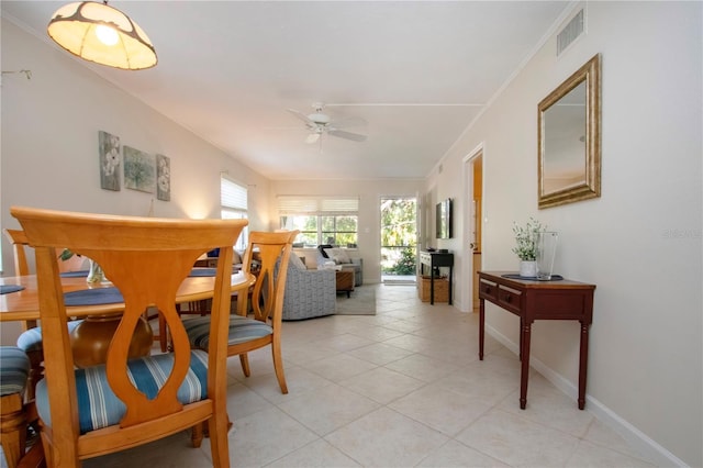 3745 Almeria Ave Unit 7S, Sarasota, FL 34239 - dining room featuring ceiling fan, light tile patterned floors, baseboards, and crown molding
