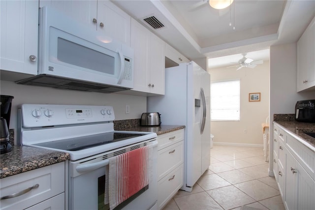 3745 Almeria Ave Unit 7S, Sarasota, FL 34239 - kitchen with white appliances, a ceiling fan, white cabinetry, light tile patterned flooring, and dark stone counters
