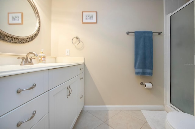 3745 Almeria Ave Unit 7S, Sarasota, FL 34239 - bathroom with vanity, tile patterned flooring, a shower with shower door, toilet, and baseboards