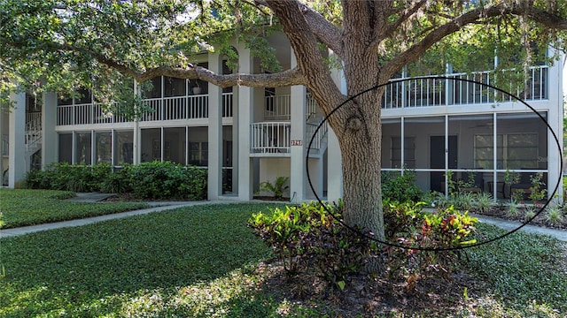 3745 Almeria Ave Unit 7S, Sarasota, FL 34239 - rear view of property with stucco siding and a lawn