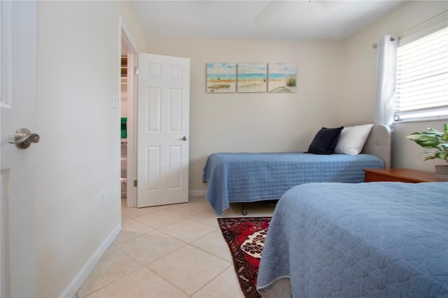 3745 Almeria Ave Unit 7S, Sarasota, FL 34239 - bedroom featuring light tile patterned flooring, a ceiling fan, and baseboards