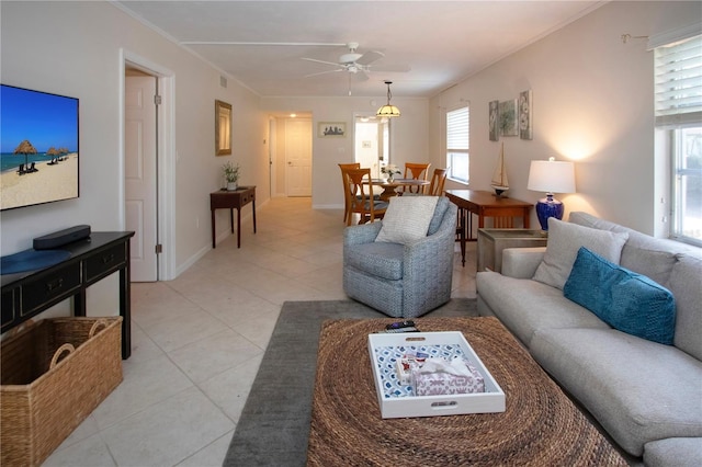 3745 Almeria Ave Unit 7S, Sarasota, FL 34239 - living room with ceiling fan, light tile patterned floors, baseboards, and crown molding