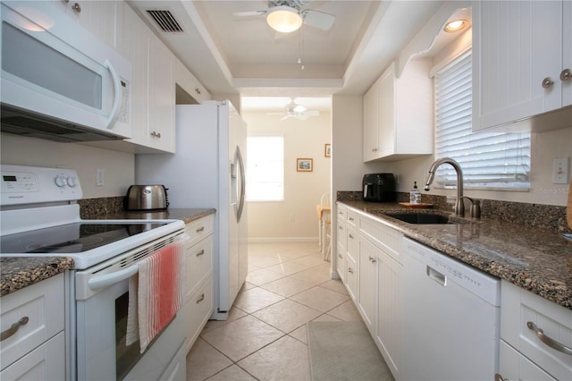 3745 Almeria Ave Unit 7S, Sarasota, FL 34239 - kitchen featuring white appliances, ceiling fan, a sink, a tray ceiling, and white cabinets